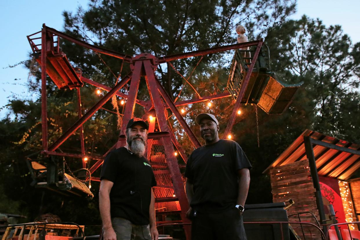 Co-owners of Wicked South Production, Tom McCormick (left) and Emeka Nwokeji (right), pose in front of a Ferris Wheel formerly seen on "Fear The Walking Dead"