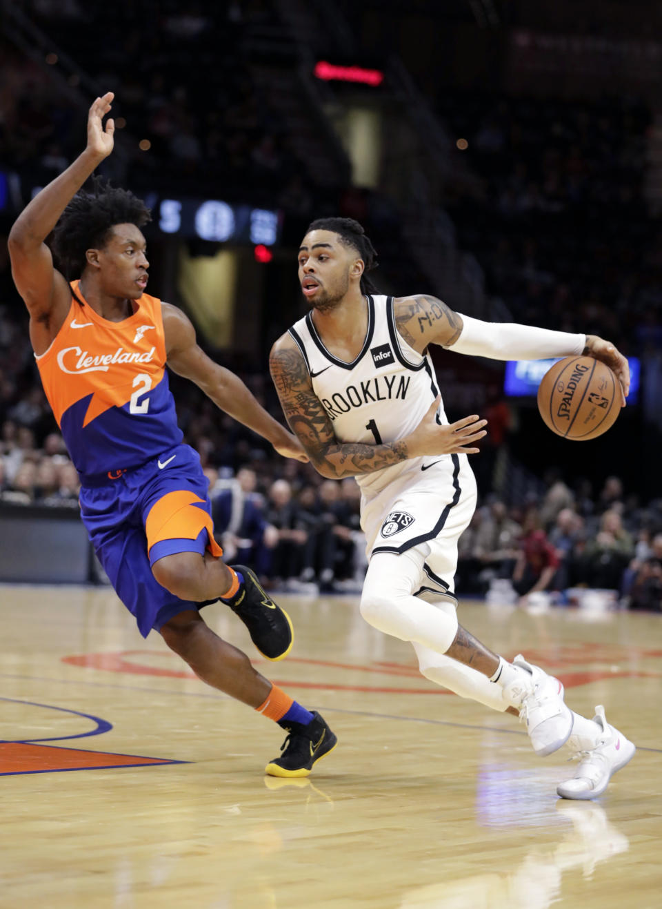 Brooklyn Nets' D'Angelo Russell (1) drives against Cleveland Cavaliers' Collin Sexton (2) in the first half of an NBA basketball game, Wednesday, Feb. 13, 2019, in Cleveland. (AP Photo/Tony Dejak)