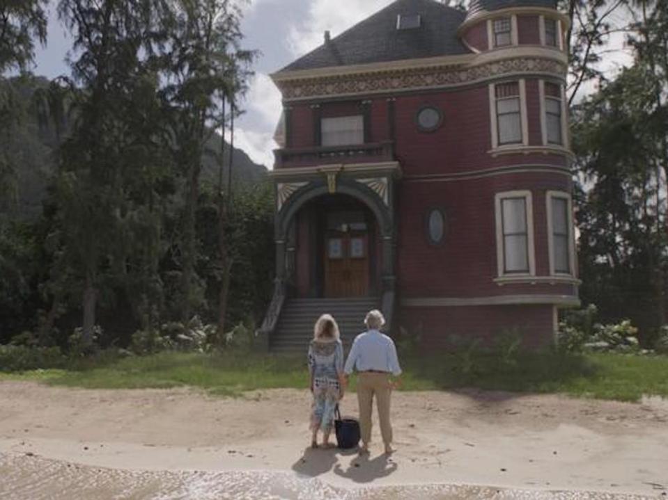 Michelle Pfeiffer as Janet van Dyne and Michael Douglas as Hank Pym on a beach in front of a house.