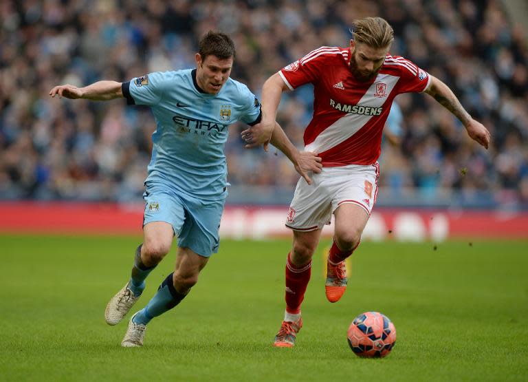 Manchester City's English midfielder James Milner (L) vies with Middlesbrough's English Midfielder Adam Clayton during their FA Cup fourth round football match in Manchester, England, on January 24, 2015