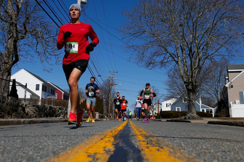 Runners make their way up Rockdale Avenue during the 2023 New Bedford Half-Marathon.