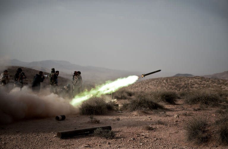 Libyan rebel fighters launch a rocket at forces loyal to Moamer Kadhafi at the front line near the southwest desert hamlet of Gualish on July 24. Libya on Monday accused NATO of killing at least seven people in an air raid on a medical clinic in Zliten east of Tripoli, as the top US officer spoke of "stalemate" in NATO's campaign