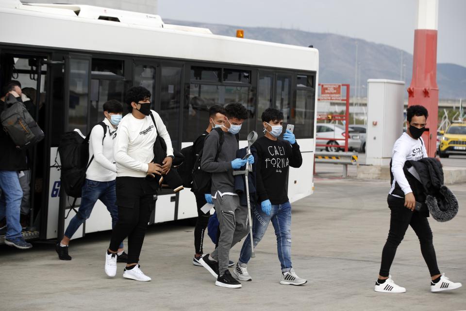 Unaccompanied children refugees wearing face masks to prevent the spread of the coronavirus, board an airplane bound for Britain at the Eleftherios Venizelos International Airport in Athens, on Monday, May 11, 2020. Sixteen asylum-seeking minors and 34 migrants were relocated as part of a migrant reunification plan agreed between the two countries. (AP Photo/Thanassis Stavrakis)