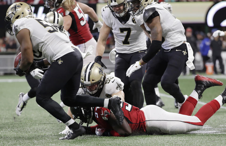 New Orleans Saints linebacker Craig Robertson (52) picks up a loose ball after a Atlanta Falcons blocked punt during the second half of an NFL football game, Sunday, Sept. 23, 2018, in Atlanta. (AP Photo/Mark Humphrey)