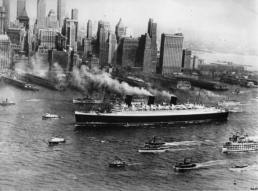 The Queen Mary in New York City with the skyline behind it