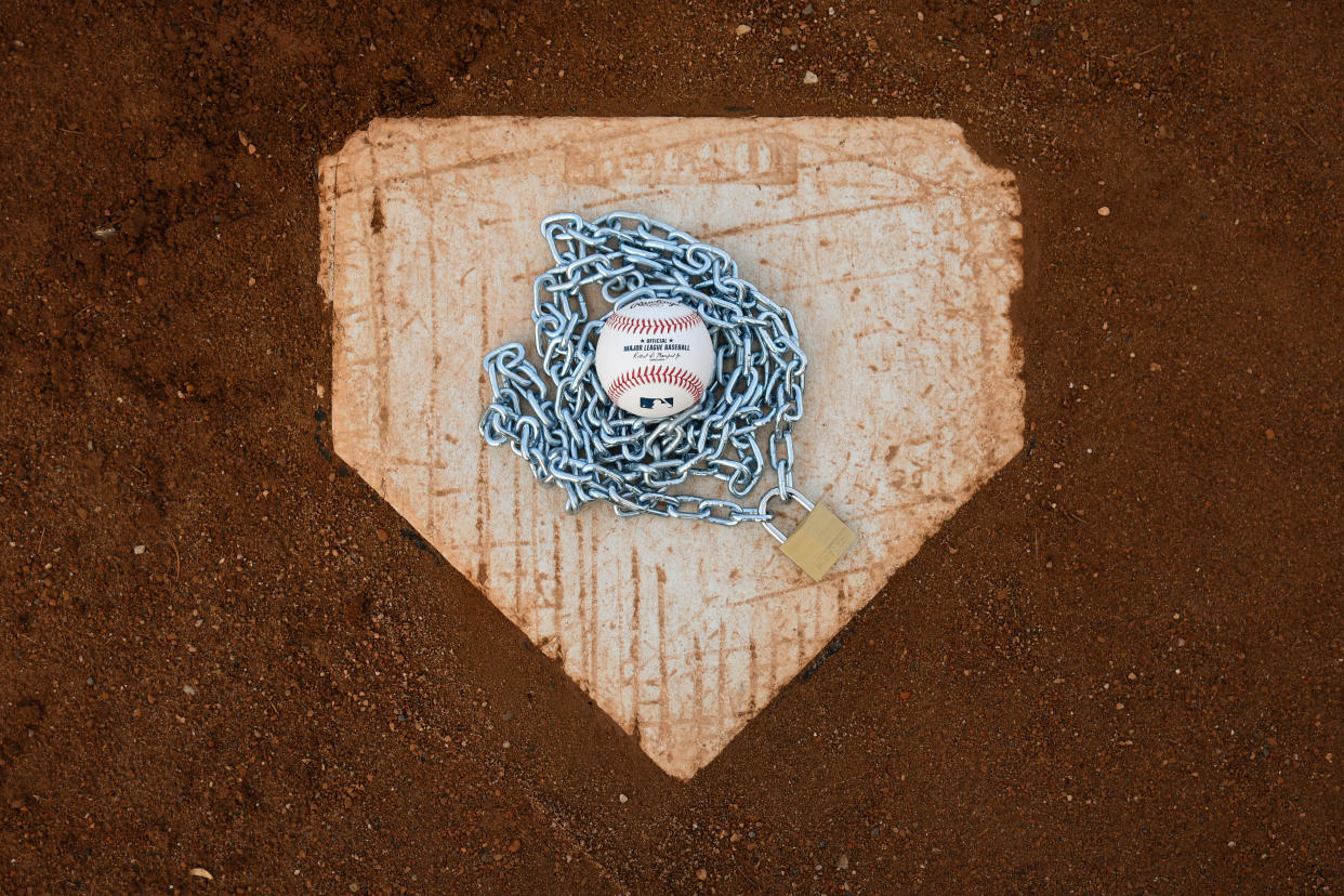 Brownsburg, IN - December 2: An Official Rawlings Major League Baseball sits with a lock and chain to represent the lockout between Major League Baseball (MLB) and the Major League Baseball Players Association (MLBPA) on December 2, 2021 in Brownsburg, IN. (Photo by James Black/Icon Sportswire via Getty Images)