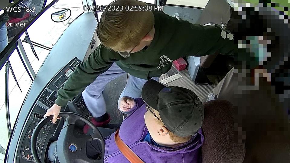 This frame capture from video inside of the bus shows Dillon Reeves, 13, a 7th grader at Carter Middle School in Warren making a heroic move when he brought his school bus to a safe stop after the driver fell ill and unconscious this week. 