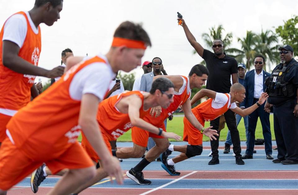 Olympic gold medalist Usain Bolt shoots a starting pistol during an event at the Ansin Sports Complex on Saturday, July 15, 2023, in Miramar, Fla. Bolt was honored by the city of Miramar during the public event where a bronze sculpture of him was unveiled.