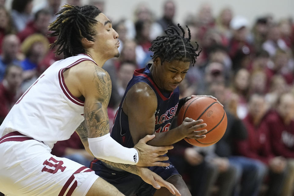 Jackson State guard Chase Adams (10) goes to the basket against Indiana guard Jalen Hood-Schifino (1) during the first half of an NCAA college basketball game, Friday, Nov. 25, 2022, in Bloomington, Ind. (AP Photo/Darron Cummings)