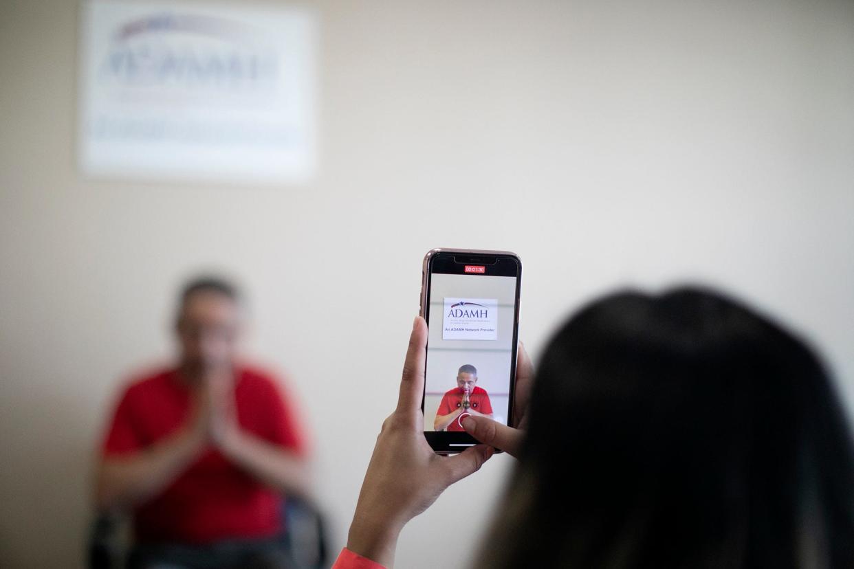 A Center for New Americans caseworker records an outreach video in June to encourage the Bhutanese community to get vaccinated at the North Community Counseling Center, which caters to Bhutanese-Nepali refugees.