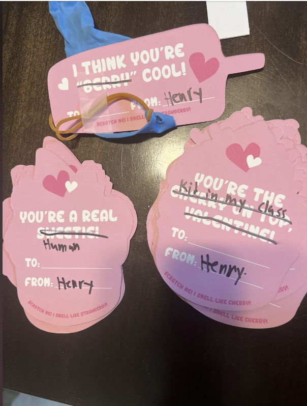 Three handmade Valentine cards, each addressed to "Henry". The cards feature playful messages, stickers, and a rubber band