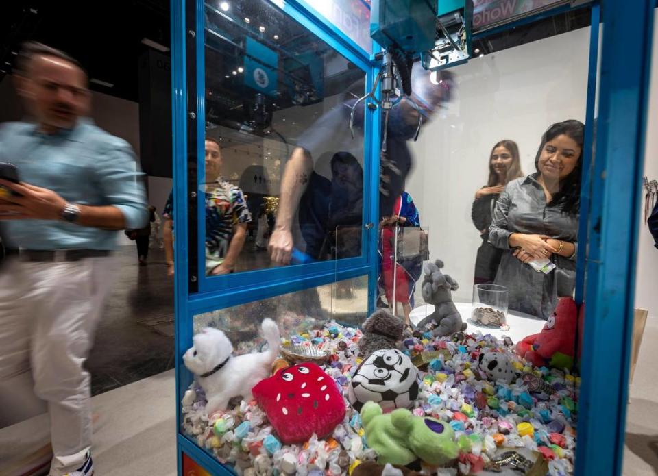 Miami Beach, Florida, December 6, 2023 - A Claw Machine that guests were invited to play with is part of Fantasy World by Artist Anthony Akinbola at Meridians during Art Basel VIP day at the Miami Beach Convention Center.