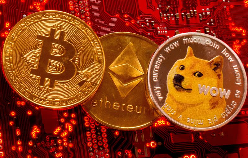 FILE PHOTO: Representations of cryptocurrencies Bitcoin, Ethereum and DogeCoin are placed on PC motherboard in this illustration taken