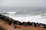 People gather to watch big waves at Praia do Norte in Nazare, Portugal, on Sunday. (Reuters)