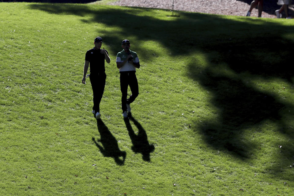 Danny Willett, left, and Rickie Fowler walk down the 6th fairway during the second round of the Masters Friday, Nov. 13, 2020, in Augusta, Ga. (Curtis Compton/Atlanta Journal-Constitution via AP)