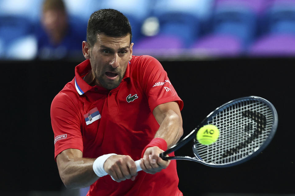 FILE - Novak Djokovic of Serbia plays a return to Zhizhen Zhang of China during the United Cup tennis tournament in Perth, Australia, Sunday, Dec. 31, 2023. Djokovic is one of the players to watch at the Australian Open. The year's first Grand Slam tennis tournament is scheduled to start at Melbourne Park on Sunday, Jan. 14. (AP Photo/Trevor Collens, File)