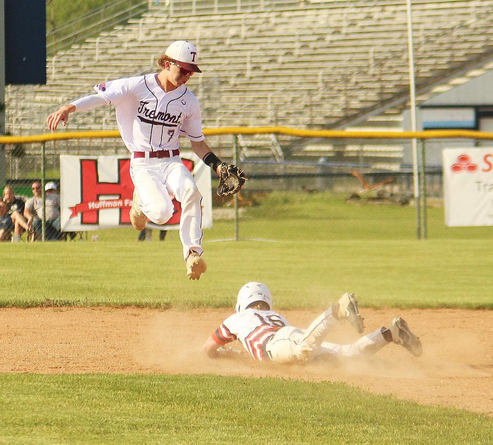 Pontiac's Drew Wayman slides safely into second base as Tremont shortstop Brady Booth leaps for the ball on a high throw on the steal attempt. Wayman, the courtesy runner for pitcher Henry Brummel, scored later in the inning to cap the 9-1 PTHS victory.