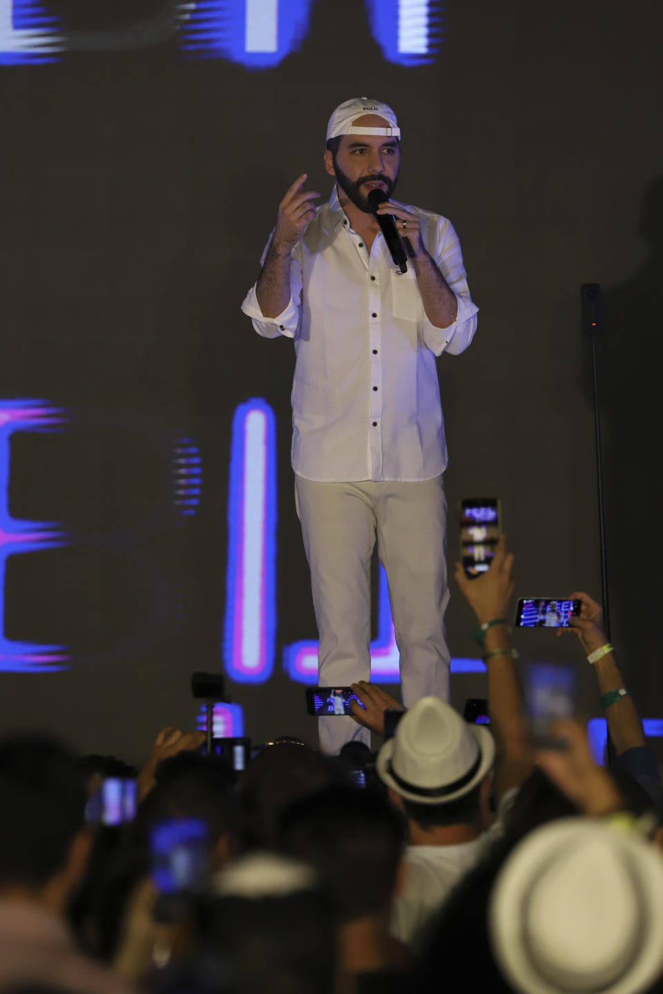 El Salvador's President Nayib Bukele participates in the closing ceremony of a congress for cryptocurrency investors in Santa Maria Mizata, El Salvador, Saturday, Nov. 20, 2021. Bukele announced during the rock concert-like atmosphere at the gathering that his government will build an oceanside "Bitcoin City" at the base of a volcano. (AP Photo/Salvador Melendez)