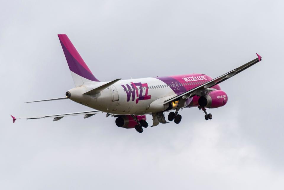 A Wizz Air plane taking off in grey skies
