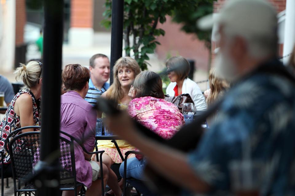 In this photo taken Saturday, July 13, 2013, customers are seen at the True Brew Barista in Concord, N.H. Thankfully, during the past five or so years the city of 42,000 has shaken off its slumber. A gaggle of eateries, an independent movie theater, several charming (and killer good) bakeries and a kick-butt independent bookstore has turned Concord into a must-stop for folks headed north for the lakes and mountains. (AP Photo/Jim Cole)