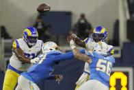 Los Angeles Rams quarterback Bryce Perkins, top right, throws under pressure from Los Angeles Chargers' Morgan Fox (56) during the first half of a preseason NFL football game Saturday, Aug. 13, 2022, in Inglewood, Calif. (AP Photo/Mark J. Terrill)