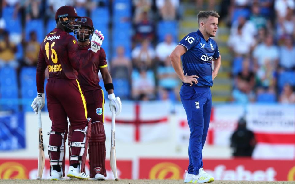 Sam Curran of England reacts to a boundary being hit off his bowling during the 1st CG United One Day International match between West Indies and England at Sir Vivian Richards Stadium on December 03, 2023 in Antigua