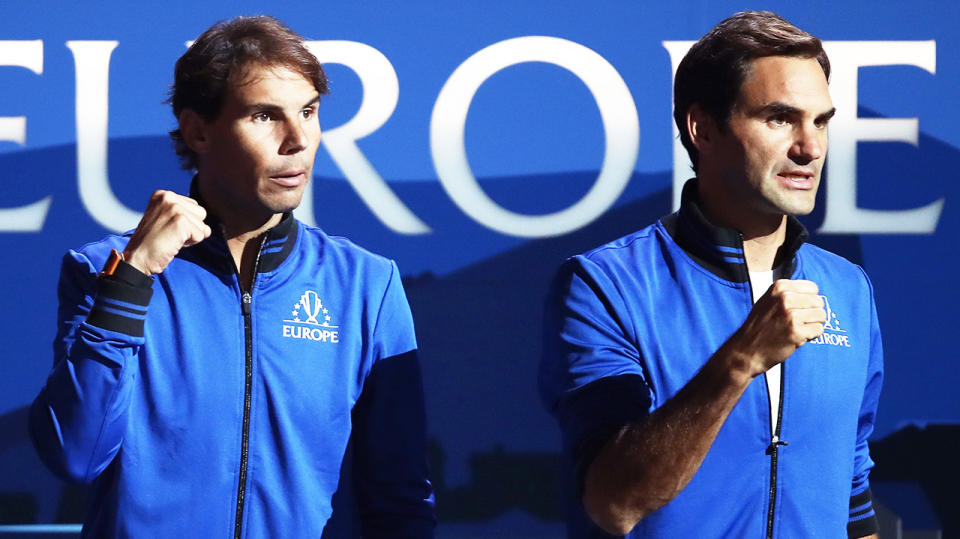 Rafael Nadal and Roger Federer fist pump after a point.