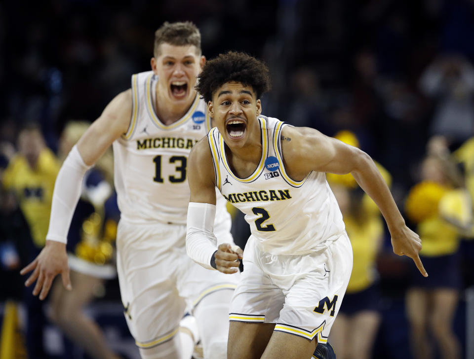 Michigan guard Jordan Poole (2) celebrates with Moritz Wagner after stunning Houston with a buzzer-beating 3-pointer to advance to the Sweet 16. (AP)