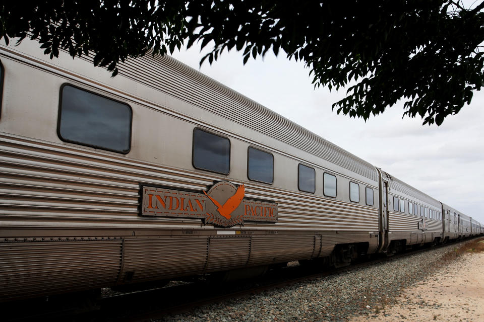 SYDNEY, AUSTRALIA - DECEMBER 09:  The Great Southern Railway's Indian Pacific arrives at Rawlinna Station on December 9, 2011 in Rawlinna, Australia. The Great Southern Railway's Indian Pacific travels the 4,352km between Sydney and Perth twice a week, crossing three states and includes the world's longest stretch of straight railway track on the Nullarbor Plain. Now in its ninth year, the Indian Pacific Outback Christmas Journey takes 65 hours to reach its destination while travelling through the Australian Outback to support remote regional communities as well as the Australian Royal Flying Doctor Service.  (Photo by Lisa Maree Williams/Getty Images)