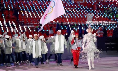 Feb 9, 2018; Pyeongchang, South Korea; Volunteer carries the OAR Olympic Athlete from Russia flag with delegates during the Pyeongchang 2018 Olympic Winter Games Opening Ceremony at Pyeongchang Olympic Stadium. Rob Schumacher-USA TODAY Sports