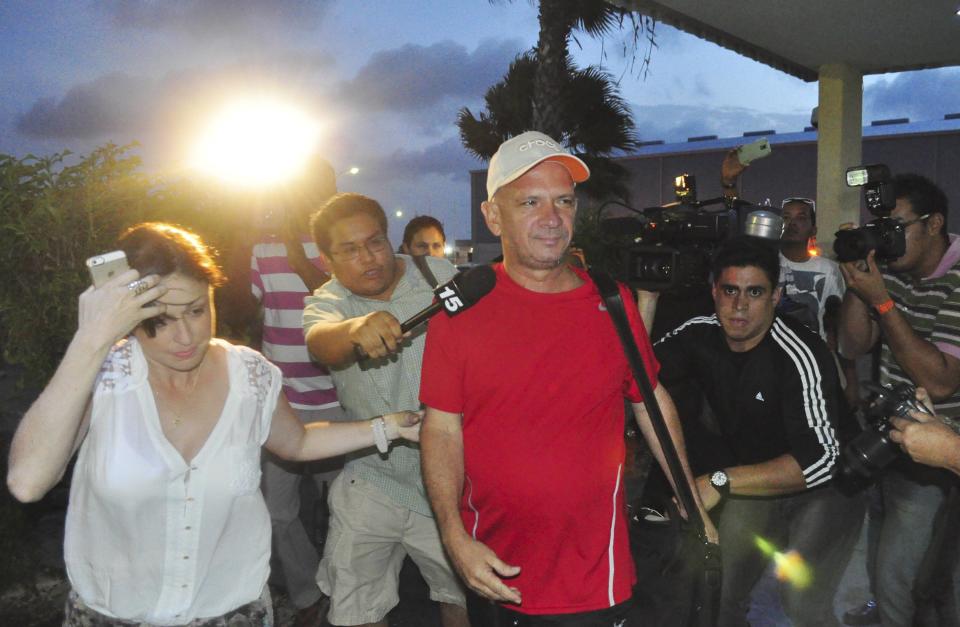 Retired General Hugo Carvajal of Venezuela, with an unidentified companion arrives at the Queen Beatrix International Airport upon being released in Oranjestad