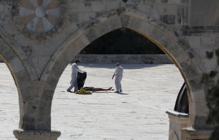 FILE PHOTO: Israeli policemen check the body of an assailant after he was shot dead by Israeli police at the compound known to Muslims as Noble Sanctuary and to Jews as Temple Mount, in Jerusalem's Old City July 14, 2017 REUTERS/Ammar Awad/File Photo