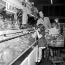 <p>From shopping carts with built-in child seats to <a href="https://progressivegrocer.com/new-frontiers-1950s" rel="nofollow noopener" target="_blank" data-ylk="slk:kiddie corrals;elm:context_link;itc:0;sec:content-canvas" class="link ">kiddie corrals</a> that were set up to entertain your children while you shopped, grocery stores in the 20th century made it easy on parents to bring their kids with them to the market.</p>
