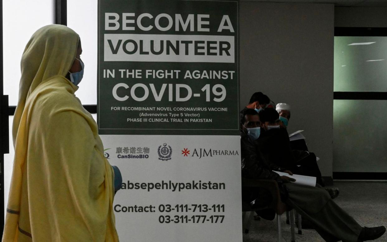 Volunteers wait to be given the jab at a hospital in Islamabad - AFP