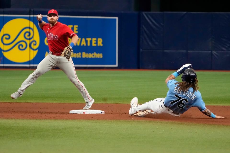 Mar 22, 2023; St. Petersburg, Florida, USA; Philadelphia Phillies second baseman Oliver Dunn steps on second base to start a double play by forcing out Tampa Bay Rays outfielder Niko Hulsizer (76) and throwing out Rays infielder Jonathan Arranda (not pictured) at first base during the eighth inning at Tropicana Field. Mandatory Credit: Dave Nelson-USA TODAY Sports