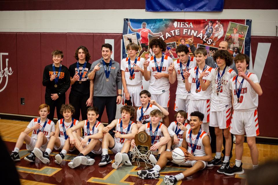 The Washington Middle School eighth-grade boys basketball team celebrates its IESA Class 8-3A state championship.