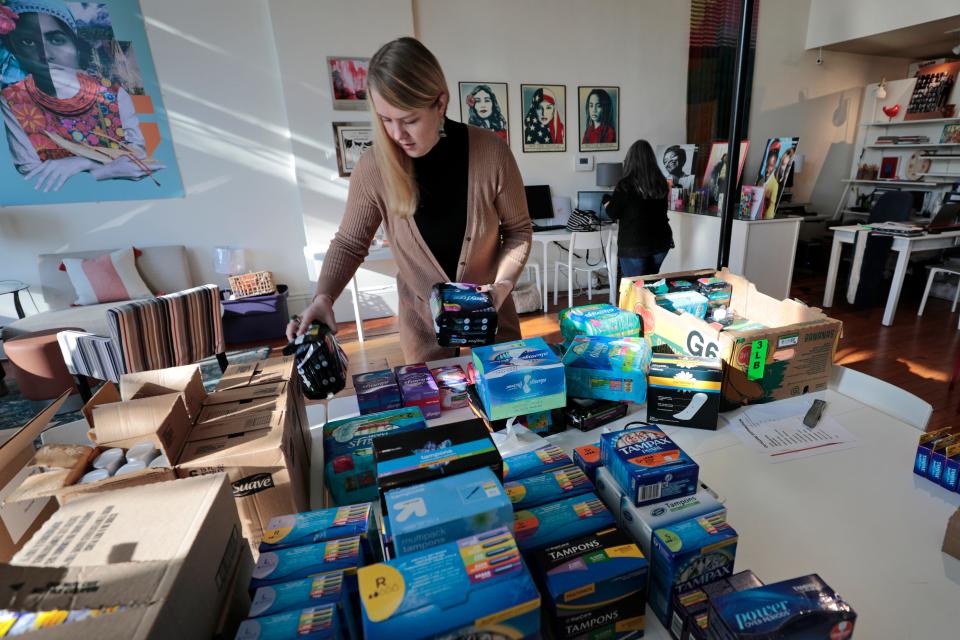 Women's Fund assistant director of operations, Makenzie Lennington, sorts some of the hygiene products they collected during a drive to give to both Grace House and Parenting Teens organizations in New Bedford.