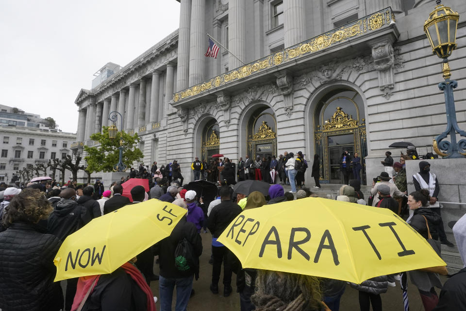 FILE - A crowd listens to speakers at a reparations rally outside of City Hall in San Francisco, on March 14, 2023. San Francisco's supervisors will offer a formal apology to Black residents for decades of racist laws and policies perpetrated by the city. All 11 supervisors have signed on as sponsors of an apology resolution to be voted on Tuesday, Feb. 27, 2024. (AP Photo/Jeff Chiu, File)