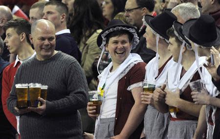 Male Welsh fans dressed as Welsh women in national costumes attend the Six Nations Championship rugby union match against Scotland at the Millennium Stadium, Cardiff, Wales, March 15, 2014. REUTERS/Rebecca Naden