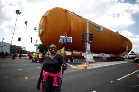 Eddye Chapman takes a picture of herself as the space shuttle Endeavour's external fuel tank ET-94 makes its way to the California Science Center in Exposition Park in Los Angeles, California, U.S. May 21, 2016. REUTERS/Lucy Nicholson