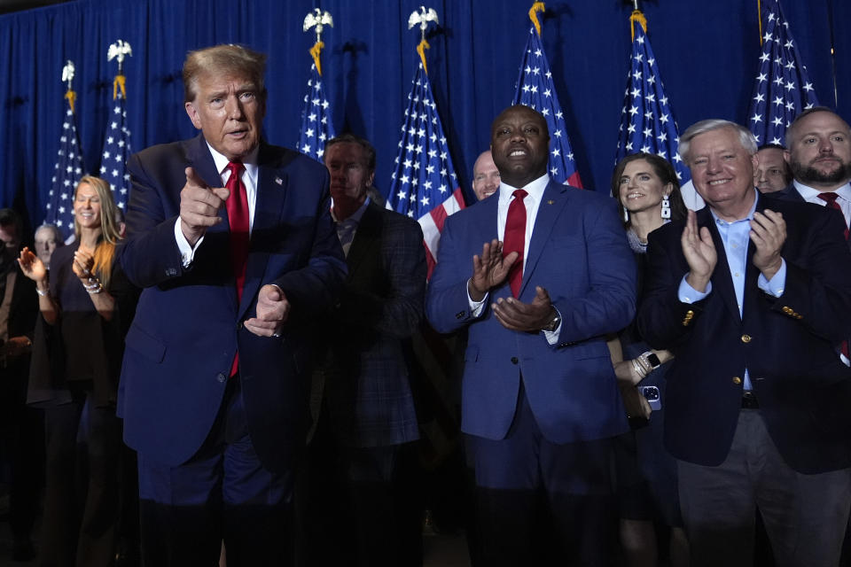 Republican presidential candidate former President Donald Trump attends a primary election night party at the South Carolina State Fairgrounds in Columbia, S.C., Saturday, Feb. 24, 2024. At right are Sen. Tim Scott, R-S.C., and Sen. Lindsey Graham, R-S.C. (AP Photo/Andrew Harnik)