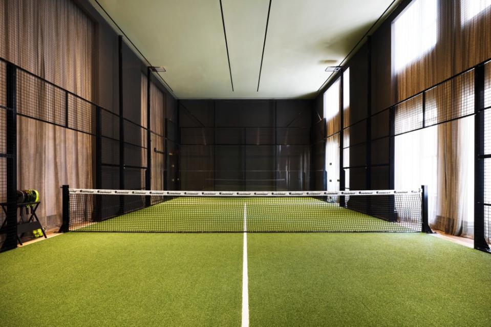An indoor padel court. Optimist Consulting