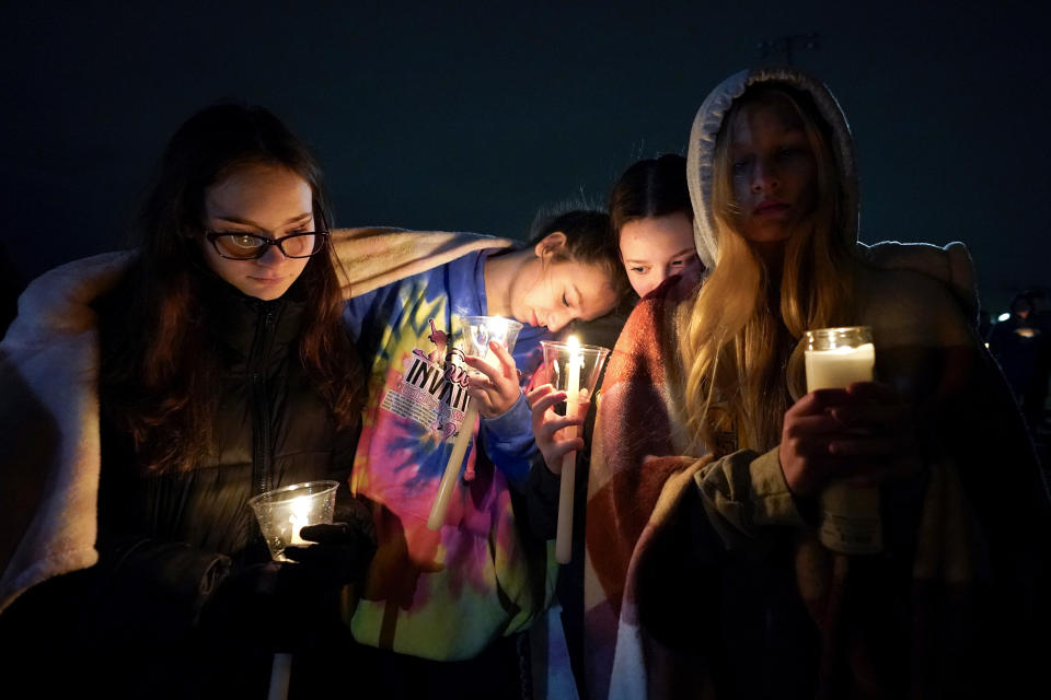 Mourners attend a candlelight vigil for Alexandria Verner at the Clawson High School football field in Clawson, Mich., Tuesday, Feb. 14, 2023. Verner was among the students killed after a gunman opened fire on the campus of Michigan State University Monday night. (AP Photo/Paul Sancya)