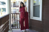 Daniella López White, of Hawaii, poses for a photo on Tuesday, May 14, 2024, on the porch of her apartment, in Boston. López White, who graduated from Emerson College in Boston this month and is on a tight budget, said TikTok influencers have helped her with tips on how to find affordable clothes at places like H&M and thrift shops. (AP Photo/Steven Senne)