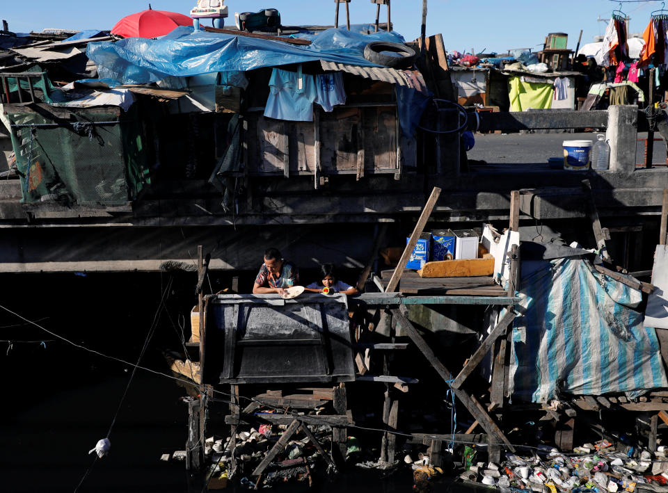 A man eats under a bridge in Tondo district, metro Manila, Philippines January 13, 2018. REUTERS/Dondi Tawatao