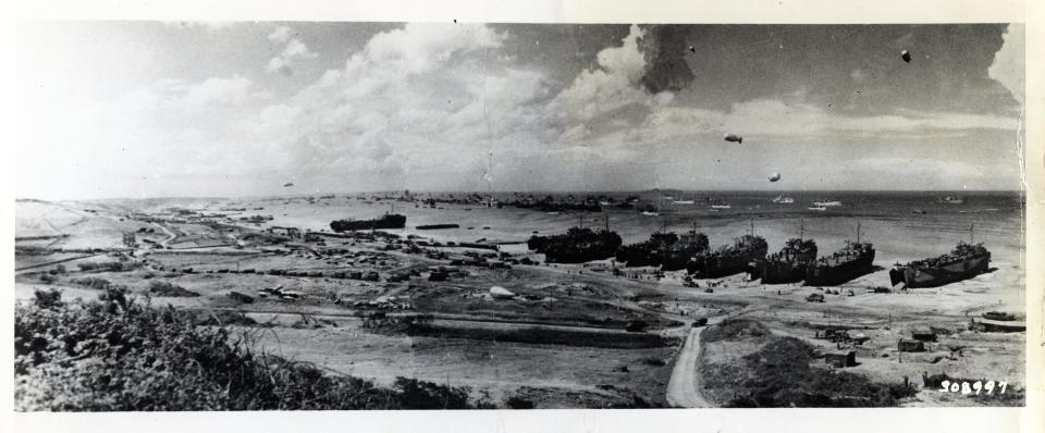 Men and assault vehicles storm the beaches of Normandy as allied landing craft make a dent in Germany's West Wall on June 6, 1944. As wave after wave of landing craft unload their cargo, men move inland and vehicles surge up the roads. 