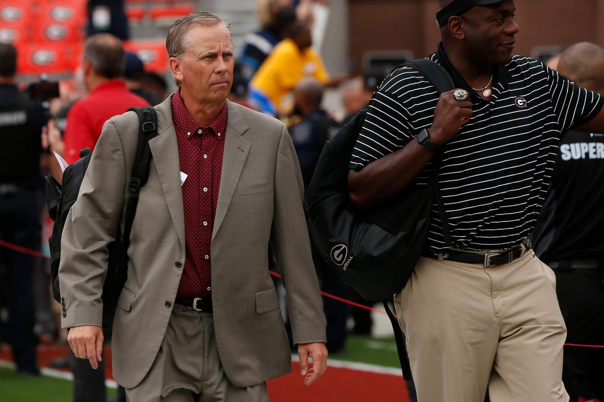 Georgia Offensive Coordinator Todd Monken (left) at the Dawg Walk before the start of a NCAA college football game between Tennessee and Georgia in Athens, Ga., on Saturday, Nov. 5, 2022.