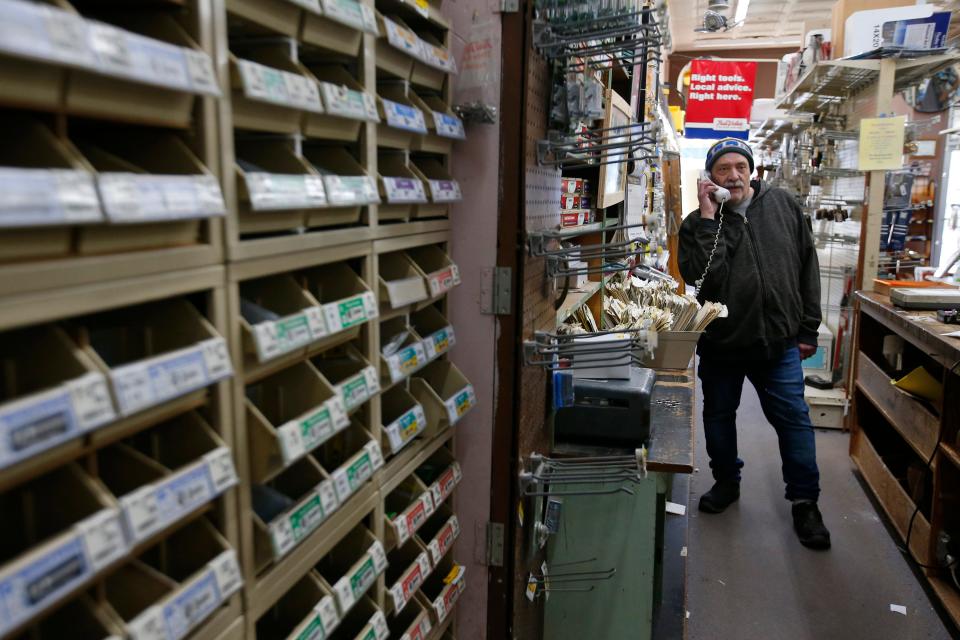 Gerard Bourassa takes a call at Bourassa Hardware on Acushnet Avenue in New Bedford set to close in January after one hundred years of operation.