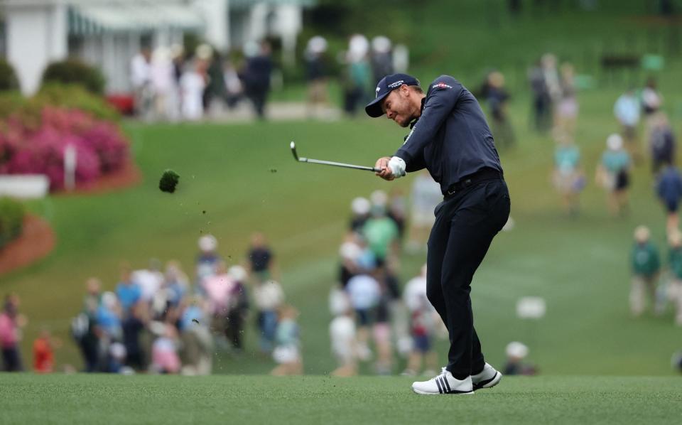 England's Danny Willett hits his approach on the 1st hole during the first round