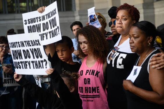 Family members of Antwon Rose II embrace as they listen to speakers during a protest calling for justice for the 17-year-old (Justin Merriman/Getty Images)